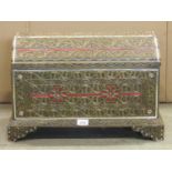 A decorative casket overlaid with scrolled and niello work style detail, 54 cm wide, together with a