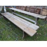 A weathered pine narrow tavern type table, the plank top with cleated ends raised on X framed
