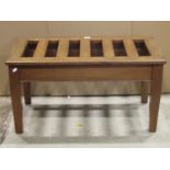A vintage luggage stand of rectangular form with open slatted top and square tapered supports, 86 cm