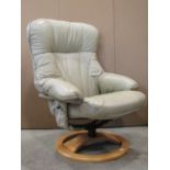 A contemporary swivel adjustable lounge chair with soft stitched leather upholstery, raised on a