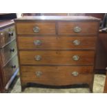 A 19th century mahogany bedroom chest of two short over three long graduated drawers with oval