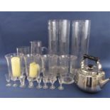 A collection of storm lantern type glass vases, tall glass jug and others