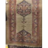 Turkish village rug with central geometric medallion decoration and floral borders upon a natural