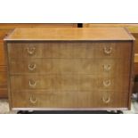A pair of E Gomme early G Plan teak bedroom chests, fitted with four long drawers with fixed loop