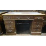 A 19th century mahogany pedestal desk of nine drawers, inset top and raised shallow gallery back,