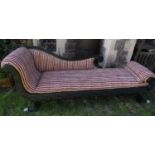 A day bed, in the Regency style, the shaped showwood frame with painted finish, raised on four swept