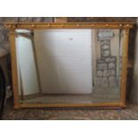 A reproduction Regency style overmantle mirror of rectangular form with bevelled edge plate