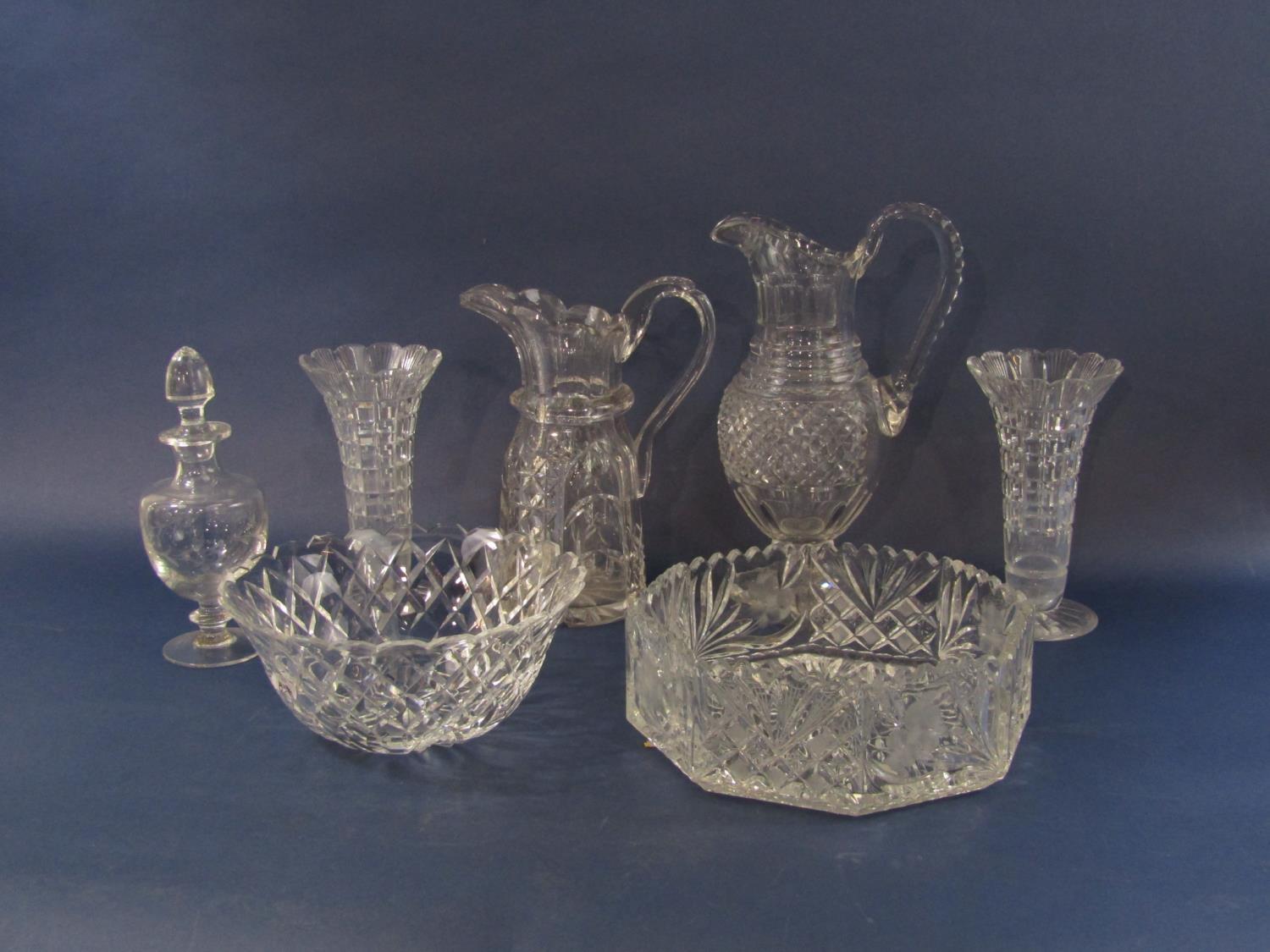 A collection of crystal cut glassware comprising two claret type jugs, a pair of flared vases, two