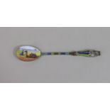 A good quality Egyptian silver enamelled souvenir spoon, the bowl decorated with kneeling man and