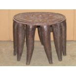 Tribal interest - An African hardwood stool of circular form with carved and reeded and geometric