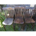 A harlequin set of six Windsor elm and beechwood lathe back kitchen chairs with saddle shaped