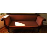 A Regency mahogany scroll end sofa, with show wood frame, raised on turned and fluted supports, with