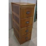 A vintage light oak floorstanding pedestal four drawer filing cabinet with anodised cup handles