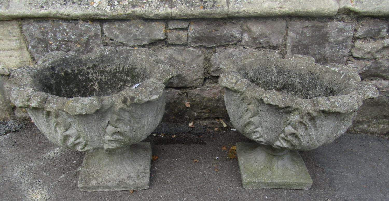 A pair of weathered composition stone garden urns with cabbage leaf bowls and square platform bases, - Image 4 of 4