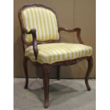 A fauteuil with alternating yellow and white striped upholstered serpentine seat with shield
