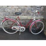 A vintage DBS ladies bicycle with sprung saddle, tubular frame, swept handlebars and aluminium