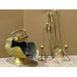 A late Victorian brass helmet shaped coal scuttle with foliate detail (complete with shovel),