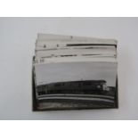 A box containing an extensive collection of black and white photographs of various locomotives -