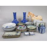 A collection of oriental ceramics including a pair of blue ground vases with all over prunus blossom
