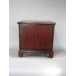 A late 19th century mahogany and fruit wood banded table top cabinet, the hinged lid enclosing a