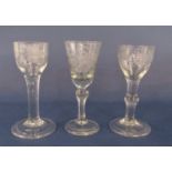 Three various stemmed cordial glasses, each decorated with floral sprays, two with very wide feet,