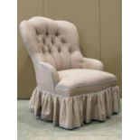 A Victorian drawing room chair with shaped and button back, upholstered finish and turned forelegs