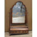 An antique Queen Anne style walnut veneered toilet mirror with moulded arched frame over an ogee box