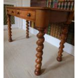 A Victorian satin birch side table with possibly later inset green leather panelled top over two
