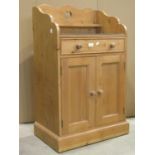 A dwarf floorstanding stripped pine side cupboard/washstand enclosed by a pair of rectangular