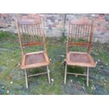 Forty eight vintage folding stained beechwood framed cafe chairs with stick backs and shell