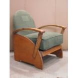 A low Art Deco style oak framed open armchair with arched geometric patterned upholstered back and