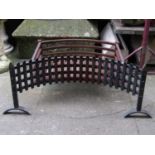 A cast iron fire basket with concave trellis front together with one other of varying design (AF)
