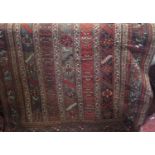 Antique Persian rug with faceted striped decoration with various floral panels upon a fawn ground,
