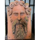 A large garden wall mask of a Grecian god, possibly Zeus, with well defined long flowing beard and