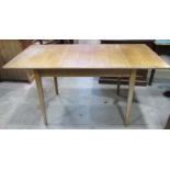 A Russell of Broadway light oak pull out extending dining table of rectangular form with single