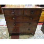 An early 19th century mahogany bedroom chest of two short over three long drawers with shaped