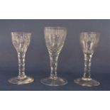 Three various facetted stemmed cordial glasses, a pair etched with a floral spray and a further with