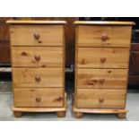 A pair of modern pine four drawer bedside chests raised on turned bun feet
