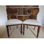 A pair of mid-19th century rosewood side chairs with kidney shaped back, upholstered seats on turned