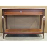 An Edwardian walnut two tier side/serving table of rectangular form with moulded outline, raised