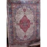 Cashmere rug with intricate scrolled foliate decoration, red central medallion upon an ivory ground,