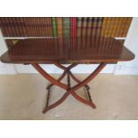 A 19th century mahogany coaching table of usual form, the rectangular top raised on a scissor shaped