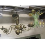 Three hanging ceiling lights of varying size and design, one in the form of string bound