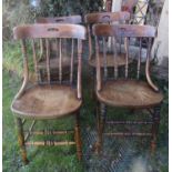 A set of four late Victorian oak and beechwood windsor spindle and curved backed dining chairs