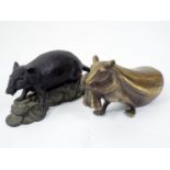 A Japanese bronze figure of a rat hauling a heavy sack, and a further rat standing on a pile on