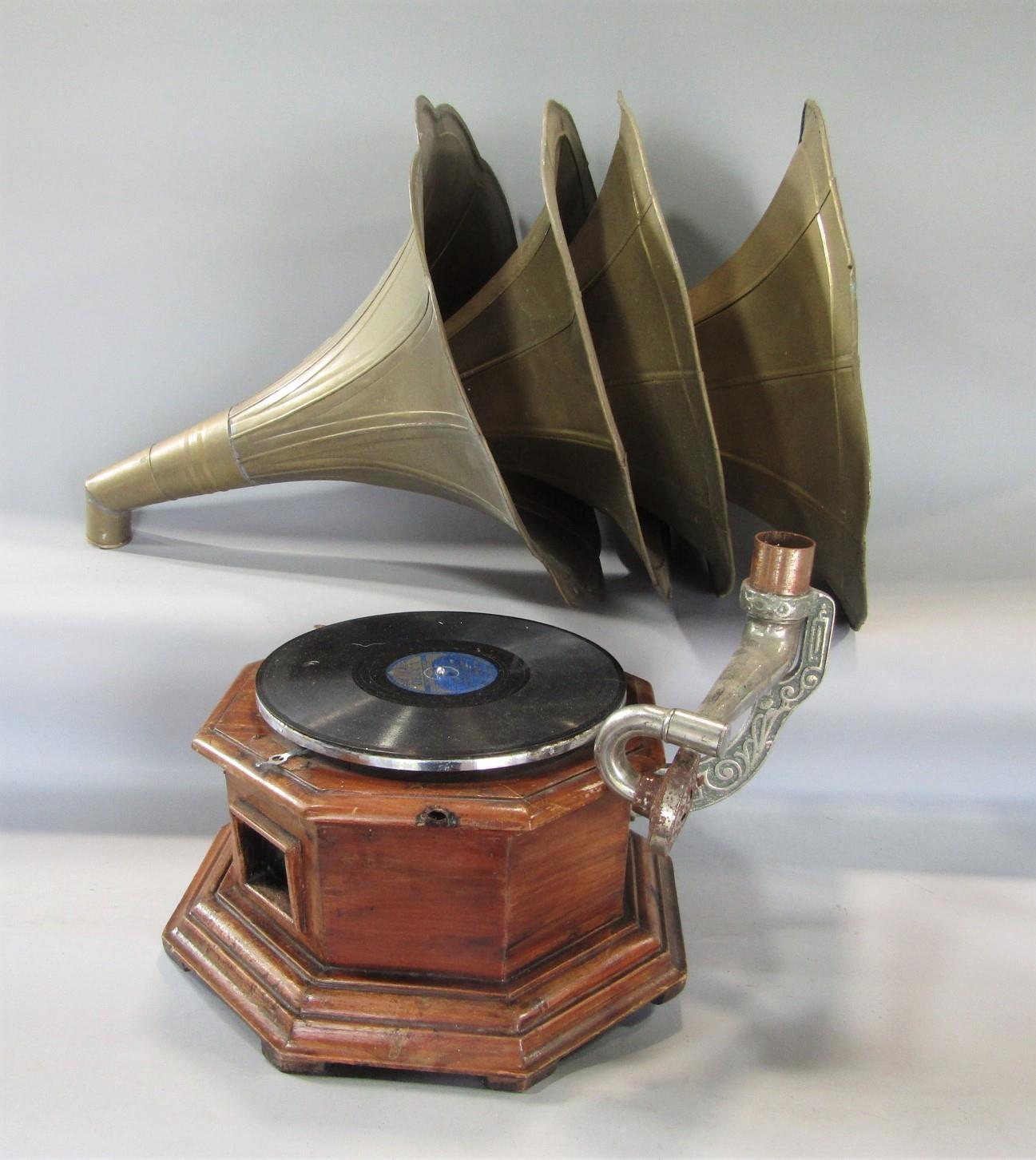 A vintage wooden octagonal gramophone/78 player with four similar brass horns (5)