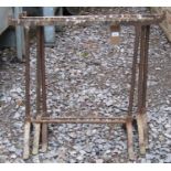 Three old iron trestles with swept feet, together with a small garden roller with tubular handle (4)