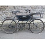 A vintage BSA tradesman's bicycle with swept back handle bars, sprung Dunlop saddle and tubular