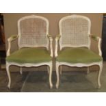 A pair of reproduction fauteuil with upholstered serpentine seats with cane panelled backs within