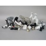 A collection of USSR ceramic animals including a running elephant, a pair of white stoats, two